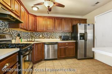 503 Harding Road, Unit 6 Freehold, NJ 07728 - Photo 11 of 23 a kitchen with stainless steel appliances granite countertop a refrigerator a sink a stove and dishwasher