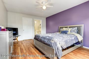 503 Harding Road, Unit 6 Freehold, NJ 07728 - Photo 16 of 23 a bedroom with a bed and a chandelier