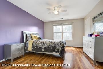 503 Harding Road, Unit 6 Freehold, NJ 07728 - Photo 17 of 23 a bedroom with a bed dresser and a window