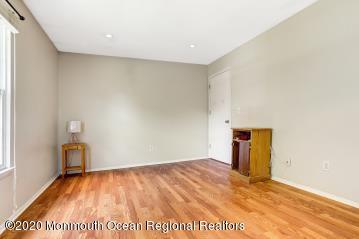 503 Harding Road, Unit 6 Freehold, NJ 07728 - Photo 19 of 23 a view of an empty room with wooden floor and a window