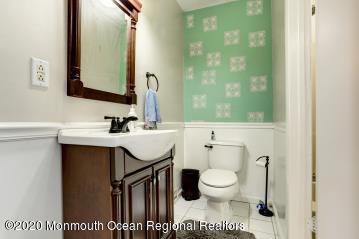 503 Harding Road, Unit 6 Freehold, NJ 07728 - Photo 22 of 23 a bathroom with a sink a toilet and mirror
