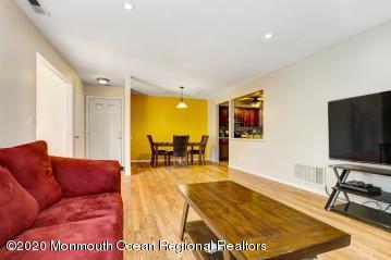 503 Harding Road, Unit 6 Freehold, NJ 07728 - Photo 6 of 23 a living room with furniture and a flat screen tv