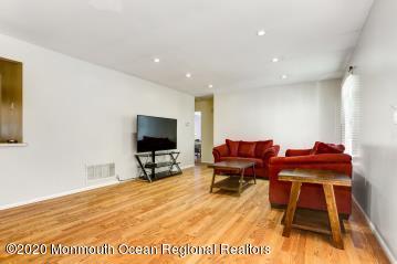 503 Harding Road, Unit 6 Freehold, NJ 07728 - Photo 7 of 23 a living room with furniture and a flat screen tv