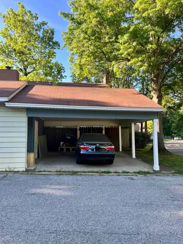 a view of house with outdoor space and sitting area