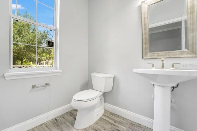 a bathroom with a sink toilet and a mirror
