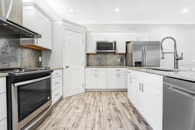 a kitchen with granite countertop a stove and a sink