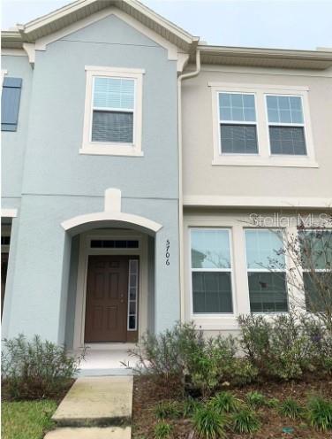 5706 Cypress Hill Road Winter Garden, FL 34787 - Photo 1 of 21 a front view of a house with a yard