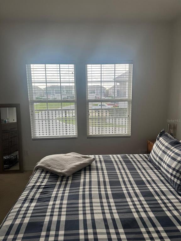 5706 Cypress Hill Road Winter Garden, FL 34787 - Photo 11 of 21 a bedroom with a bed and a window