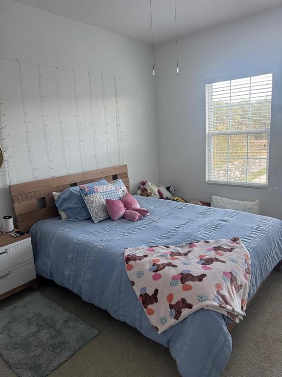 5706 Cypress Hill Road Winter Garden, FL 34787 - Photo 15 of 21 a bedroom with a bed and window