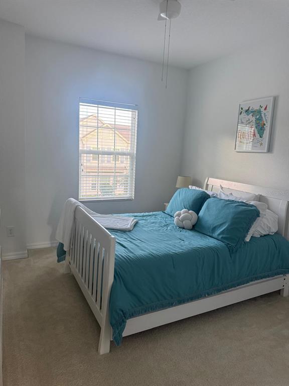 5706 Cypress Hill Road Winter Garden, FL 34787 - Photo 16 of 21 a bed sitting in a bedroom next to a window