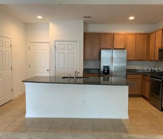 5706 Cypress Hill Road Winter Garden, FL 34787 - Photo 4 of 21 a kitchen with stainless steel appliances granite countertop a refrigerator a stove and a sink