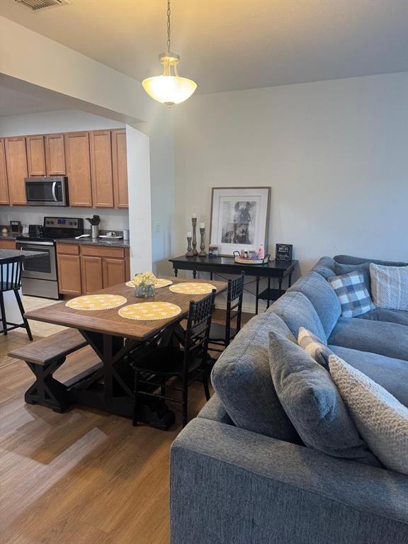 5706 Cypress Hill Road Winter Garden, FL 34787 - Photo 5 of 21 a living room with a couch a dining table and kitchen view