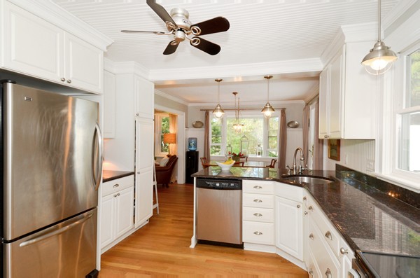 50 Topsfield Road Ipswich, MA 01938 - Photo 12 of 29 a kitchen with white cabinets and stainless steel appliances