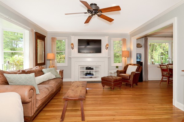 50 Topsfield Road Ipswich, MA 01938 - Photo 4 of 29 a living room with furniture floor to ceiling window hardwood floor and a flat screen tv