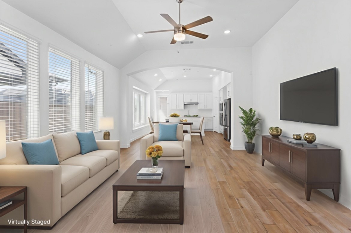 10227 Van Gogh Court Iowa Colony, TX 77578 - Photo 4 of 25 Staged living and dining areas featuring abundant natural light, elegant finishes, and seamless flow, perfect for both relaxing and entertaining.