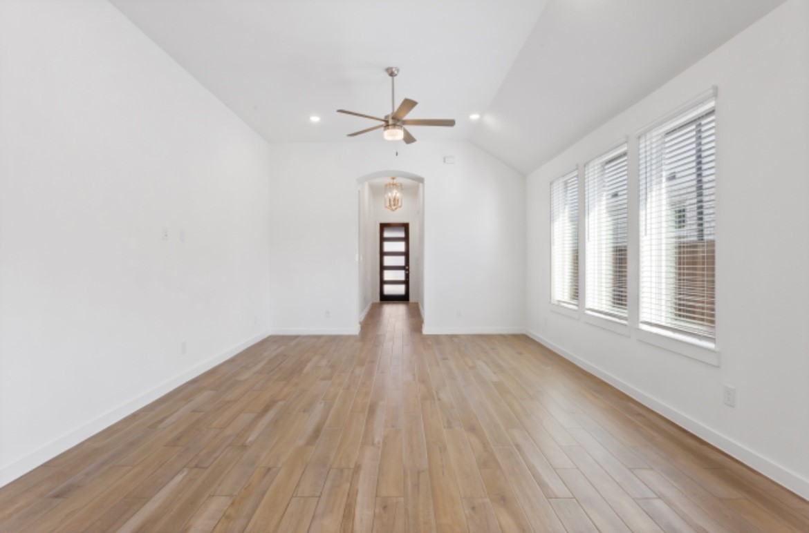 10227 Van Gogh Court Iowa Colony, TX 77578 - Photo 5 of 25 Inviting living and dining areas featuring abundant natural light, elegant finishes, and seamless flow, perfect for both relaxing and entertaining.