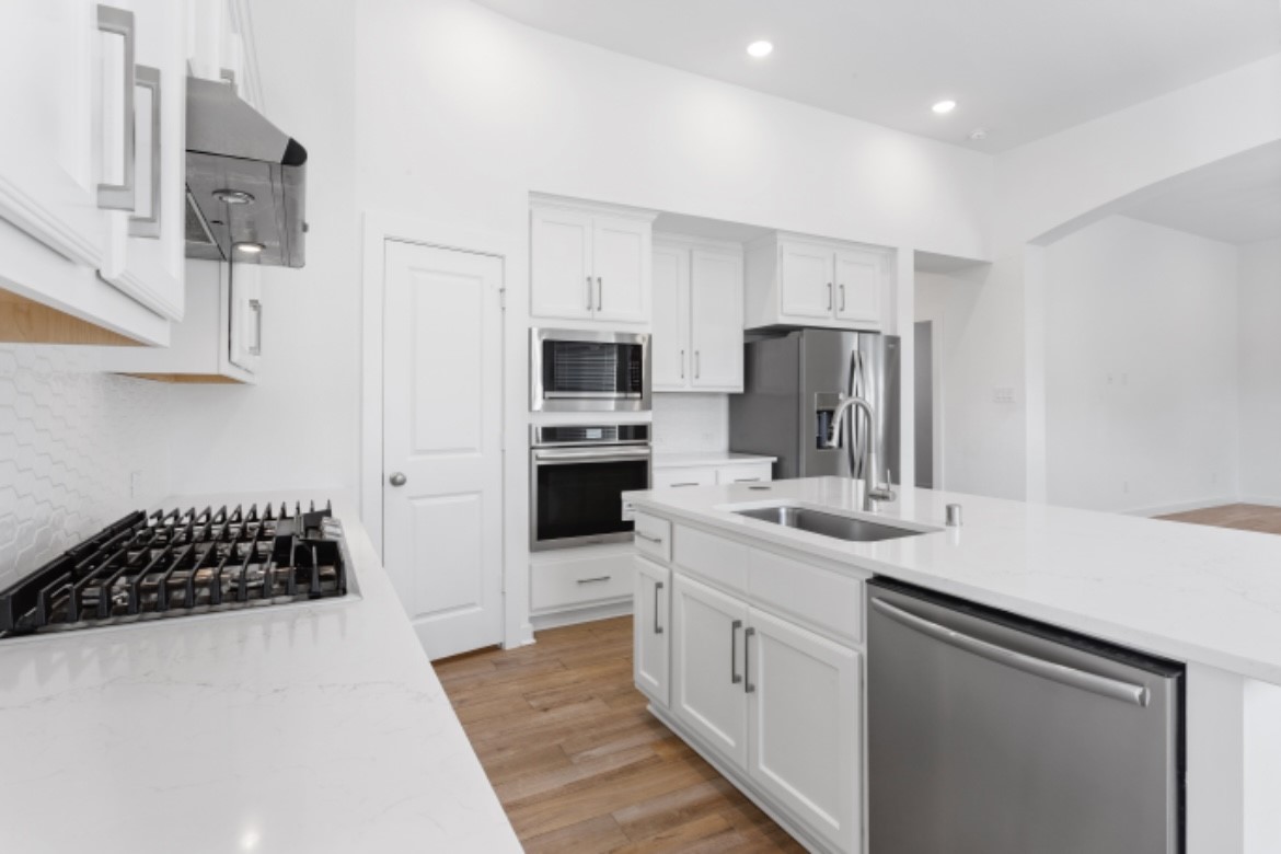 10227 Van Gogh Court Iowa Colony, TX 77578 - Photo 7 of 25 Gorgeous kitchen island topped with pristine white granite for sleek, elegant look