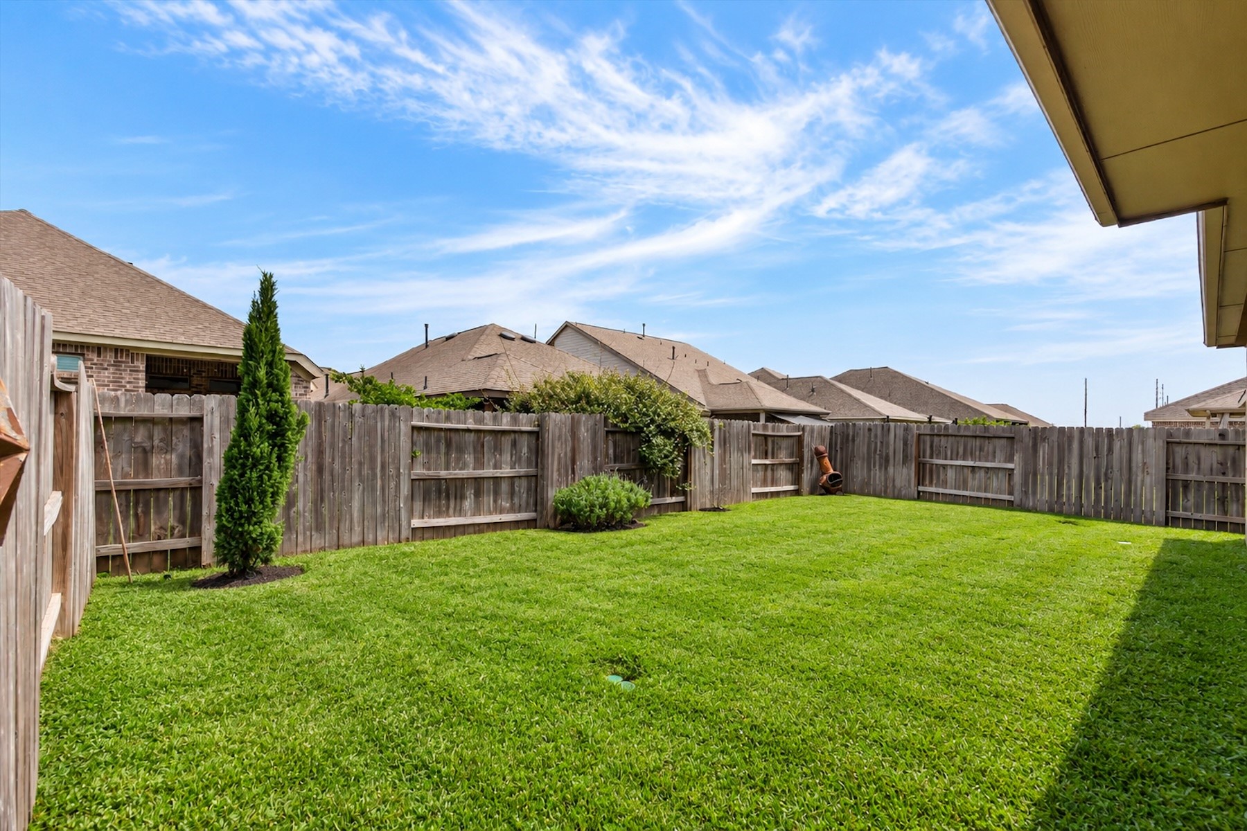 23026 Needle Grass Road Katy, TX 77493 - Photo 27 of 33 Fully fenced backyard with lush green lawn and plenty of play space.