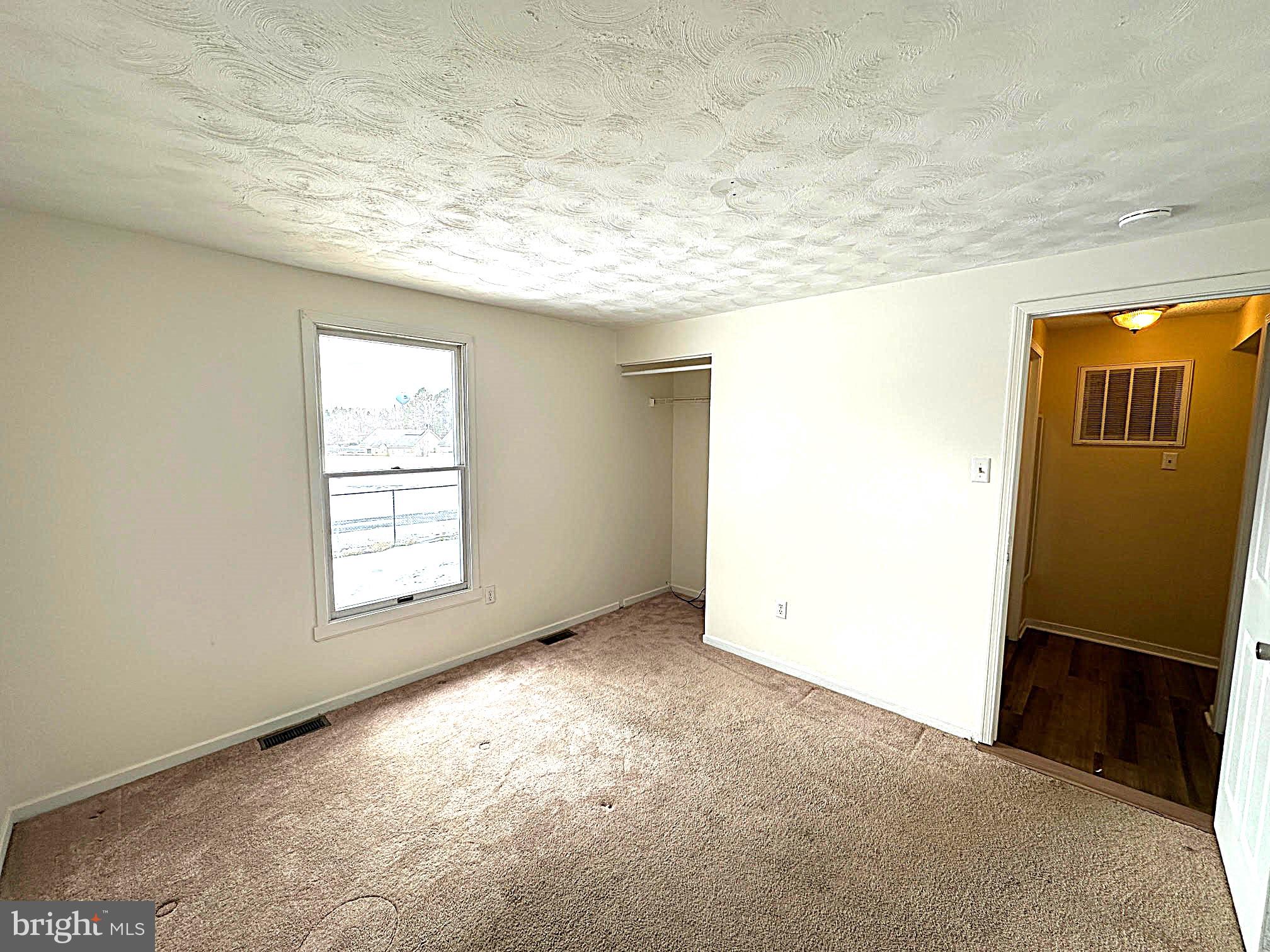 119 Cove Point Road Lusby, MD 20657 - Photo 15 of 22 an empty room with windows