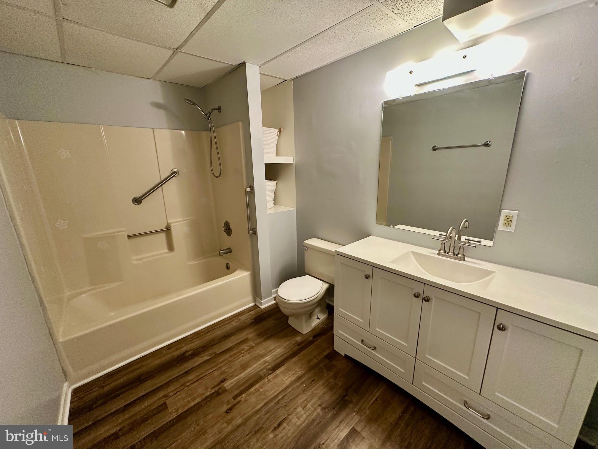 119 Cove Point Road Lusby, MD 20657 - Photo 5 of 22 a bathroom with a tub sink toilet and a mirror
