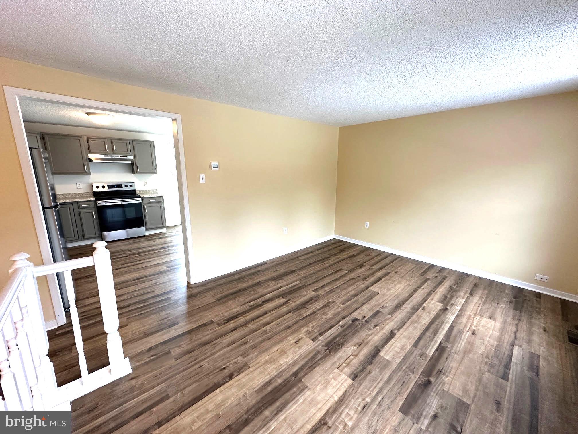 119 Cove Point Road Lusby, MD 20657 - Photo 10 of 22 a view of a room with wooden floor and furniture