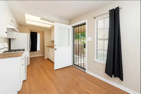 a view of a kitchen with a sink and a window