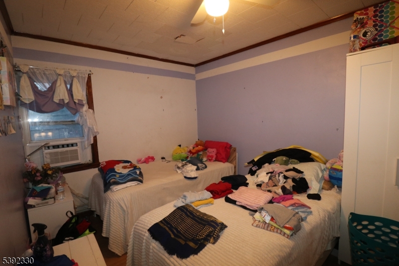 233 Adams Street Newark, NJ 07105 - Photo 11 of 14 a room with toys and dresser