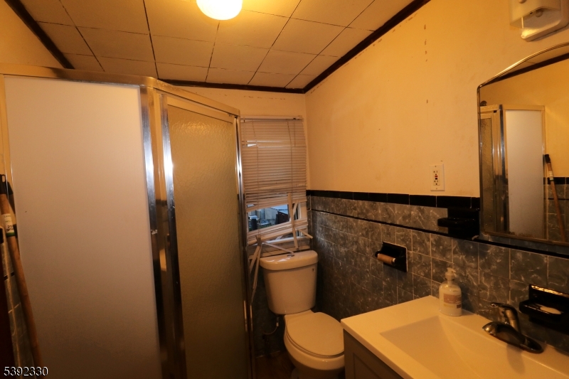 233 Adams Street Newark, NJ 07105 - Photo 12 of 14 a bathroom with a toilet a sink and shower