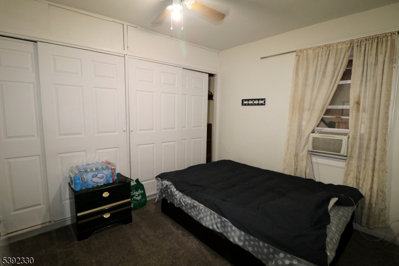 233 Adams Street Newark, NJ 07105 - Photo 2 of 14 a bedroom with a bed and a window