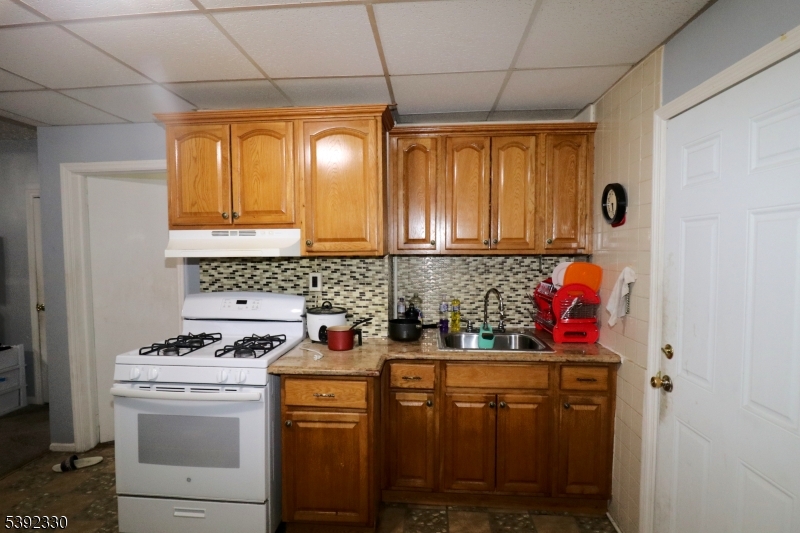 233 Adams Street Newark, NJ 07105 - Photo 6 of 14 a kitchen with stainless steel appliances a stove a refrigerator and cabinets