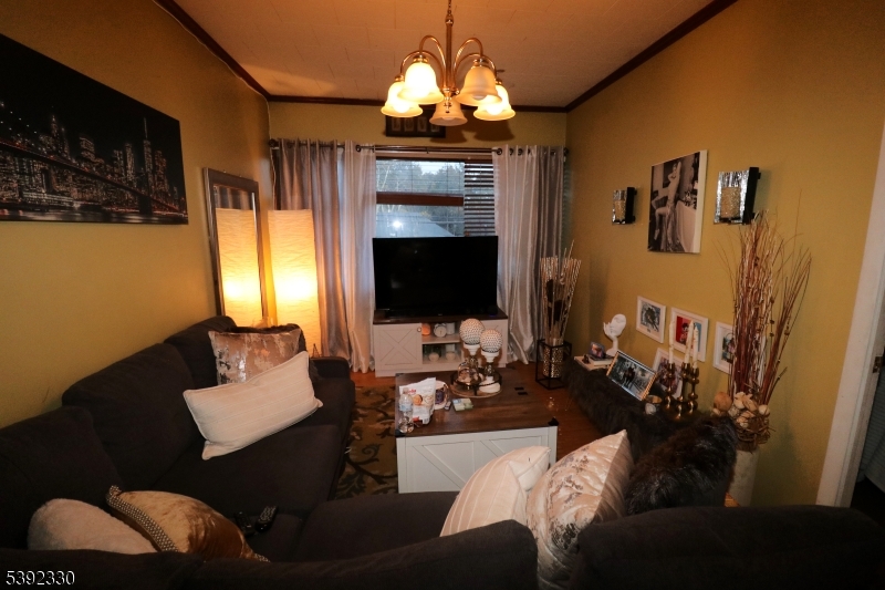 233 Adams Street Newark, NJ 07105 - Photo 9 of 14 a living room with furniture and a flat screen tv