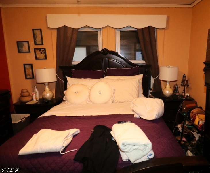 233 Adams Street Newark, NJ 07105 - Photo 10 of 14 a bedroom with a bed and a painting on the wall