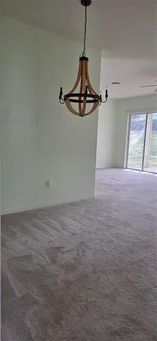 a view of a room with window and a ceiling fan