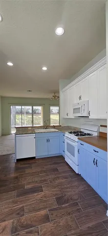 a large kitchen with granite countertop a large counter top and sink
