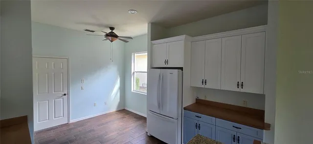 a kitchen with stainless steel appliances a refrigerator and cabinets