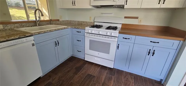 a kitchen with cabinets appliances and a sink