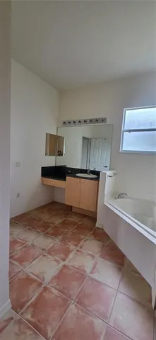 a view of kitchen and empty room