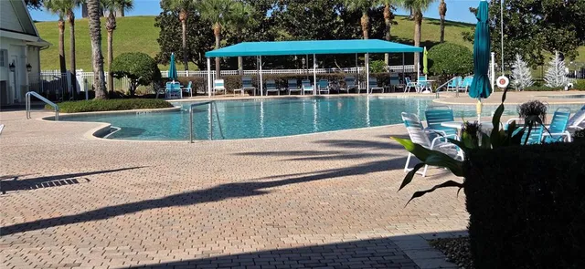 a view of a table and chairs under an umbrella in patio