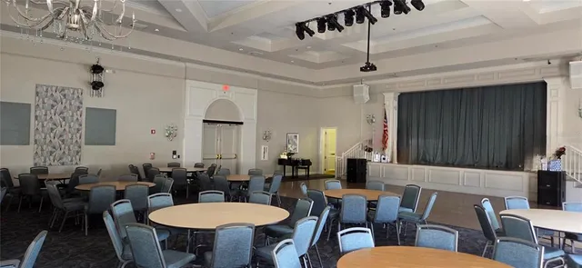 a view of a a dining room with furniture window and wooden floor