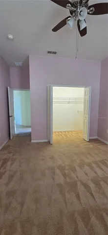 a view of empty room with ceiling fan