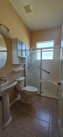a bathroom with a toilet a sink and shower