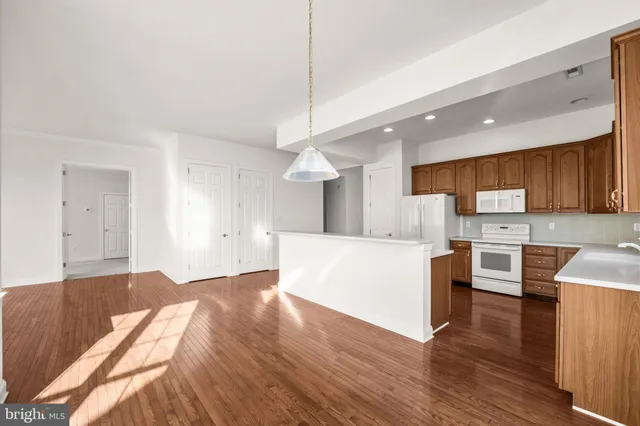 a view of kitchen with microwave a stove top oven and cabinets