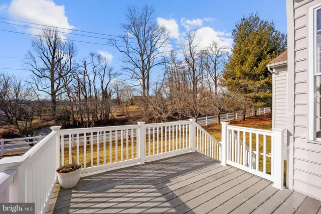 a view of a wooden deck with a yard