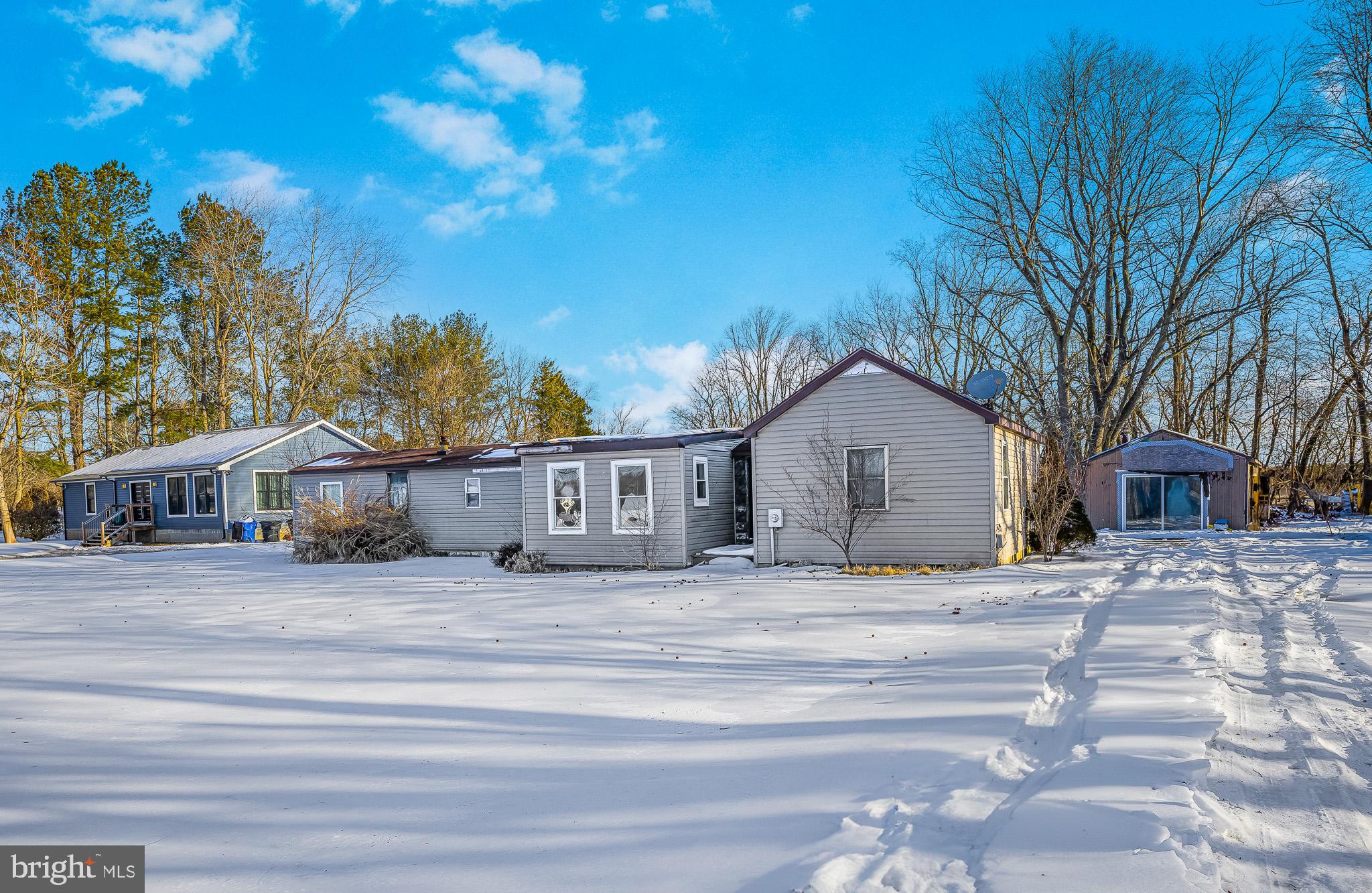 1408 Blackiston Road Clayton, DE 19938 - Photo 1 of 20 a yellow house with trees in front of it