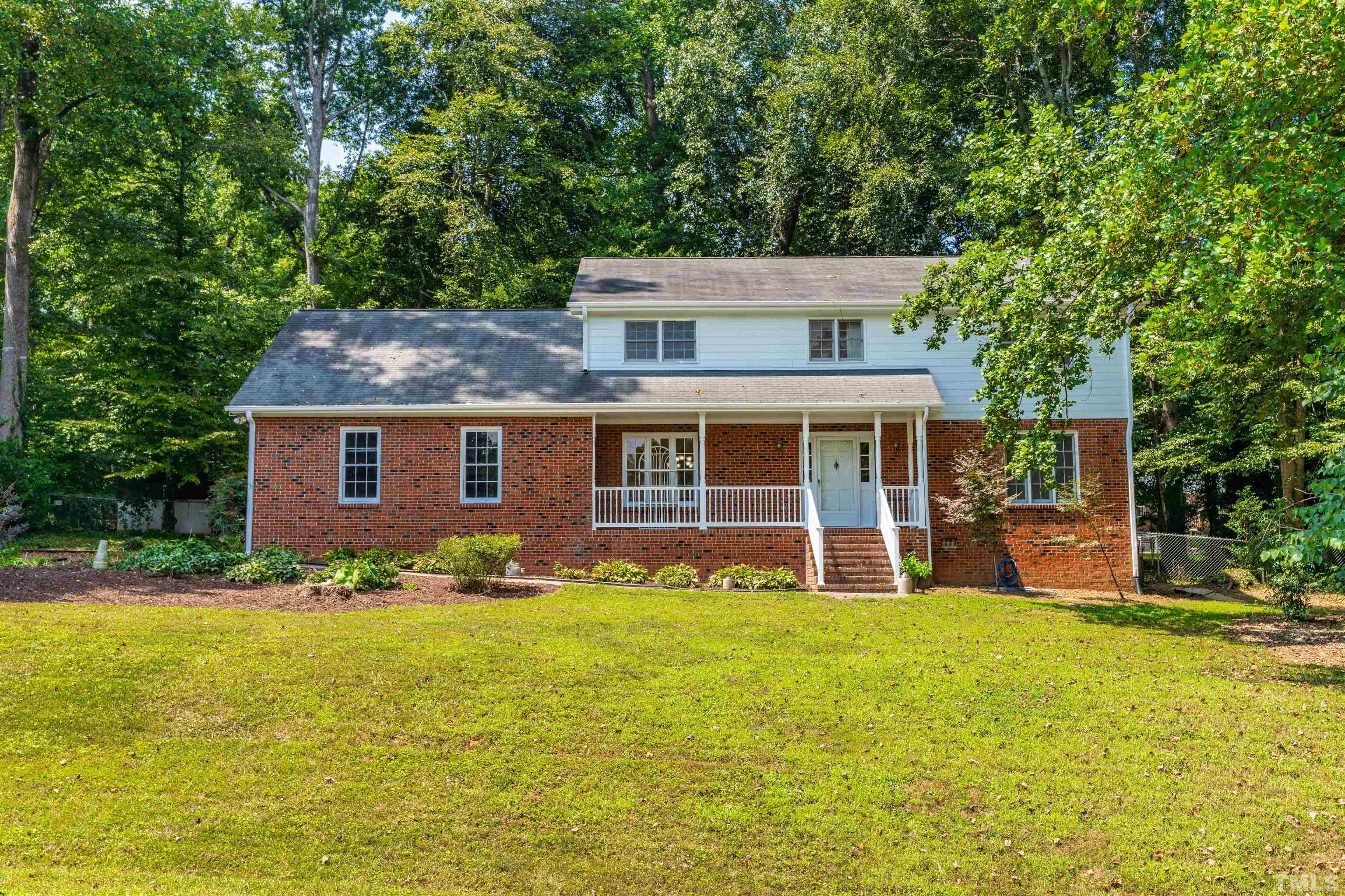 8645 Valley Brook Drive Raleigh, NC 27613 - Photo 1 of 32 a view of a house with a yard