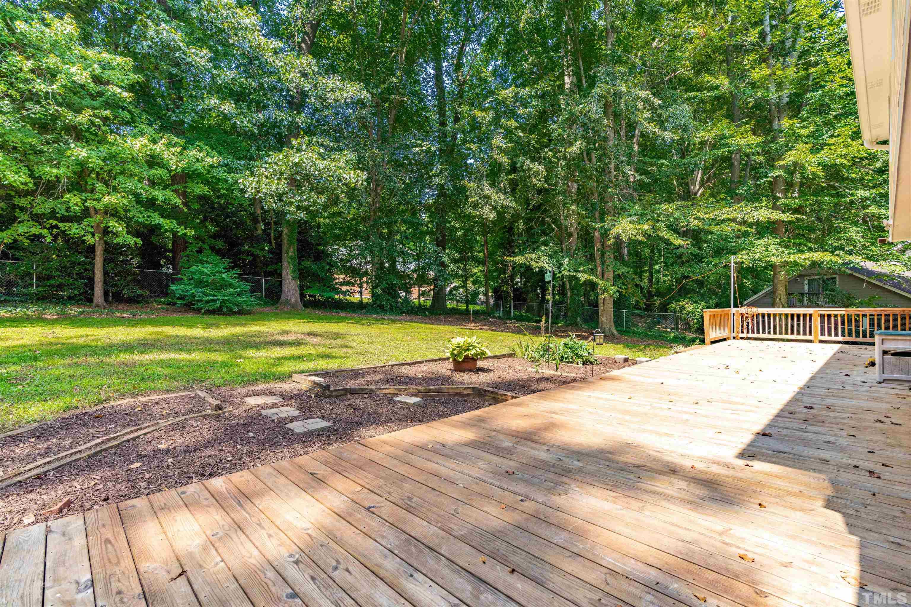 8645 Valley Brook Drive Raleigh, NC 27613 - Photo 16 of 32 a view of a swimming pool with a yard and large trees