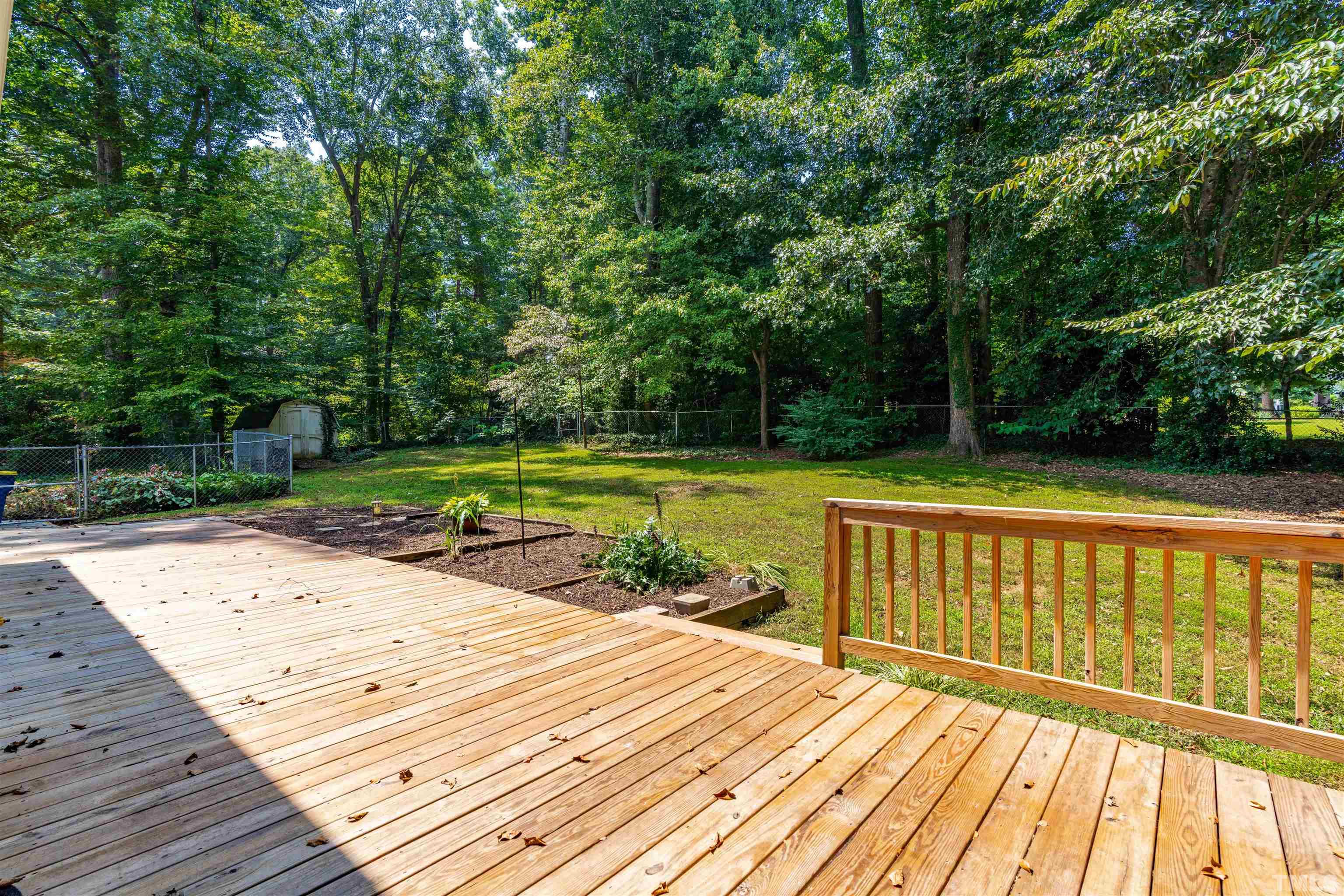 8645 Valley Brook Drive Raleigh, NC 27613 - Photo 17 of 32 a view of a wooden deck with a yard