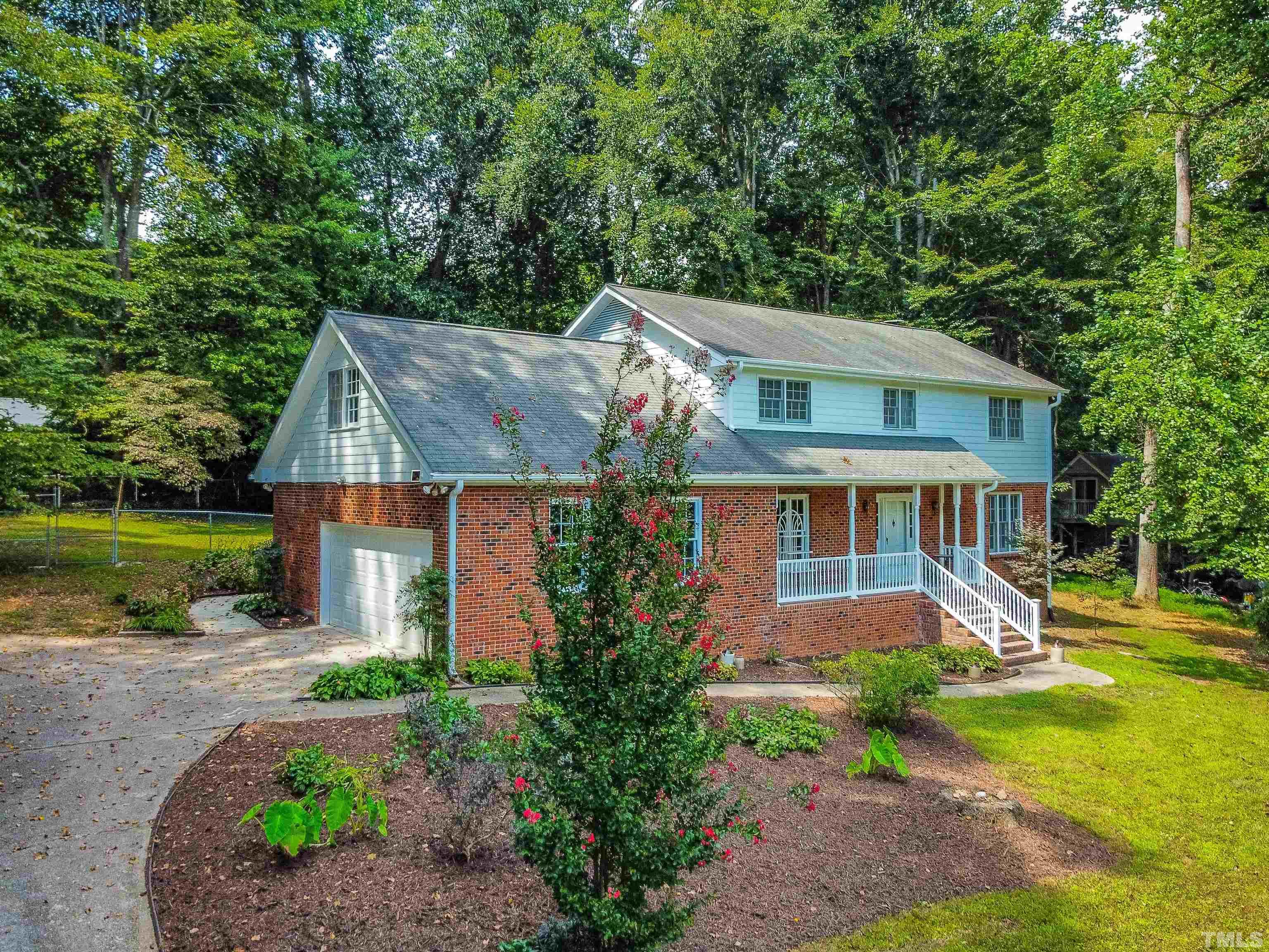 8645 Valley Brook Drive Raleigh, NC 27613 - Photo 2 of 32 a front view of a house with garden