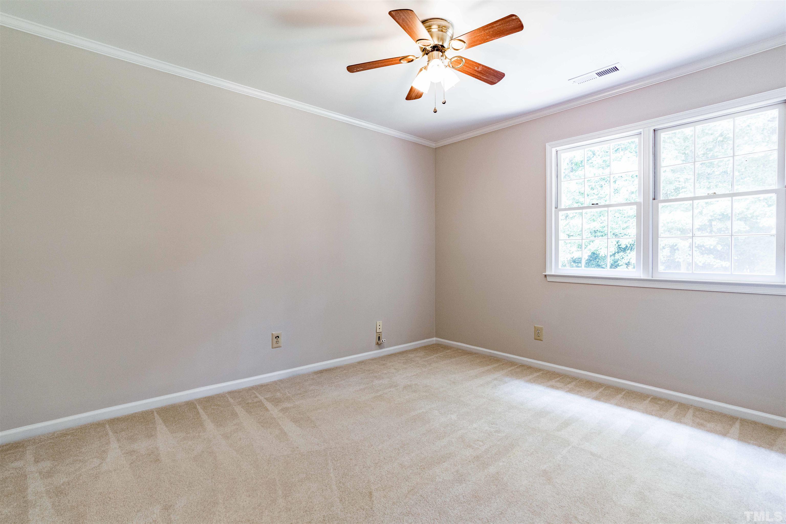 8645 Valley Brook Drive Raleigh, NC 27613 - Photo 23 of 32 an empty room with a window and a fan