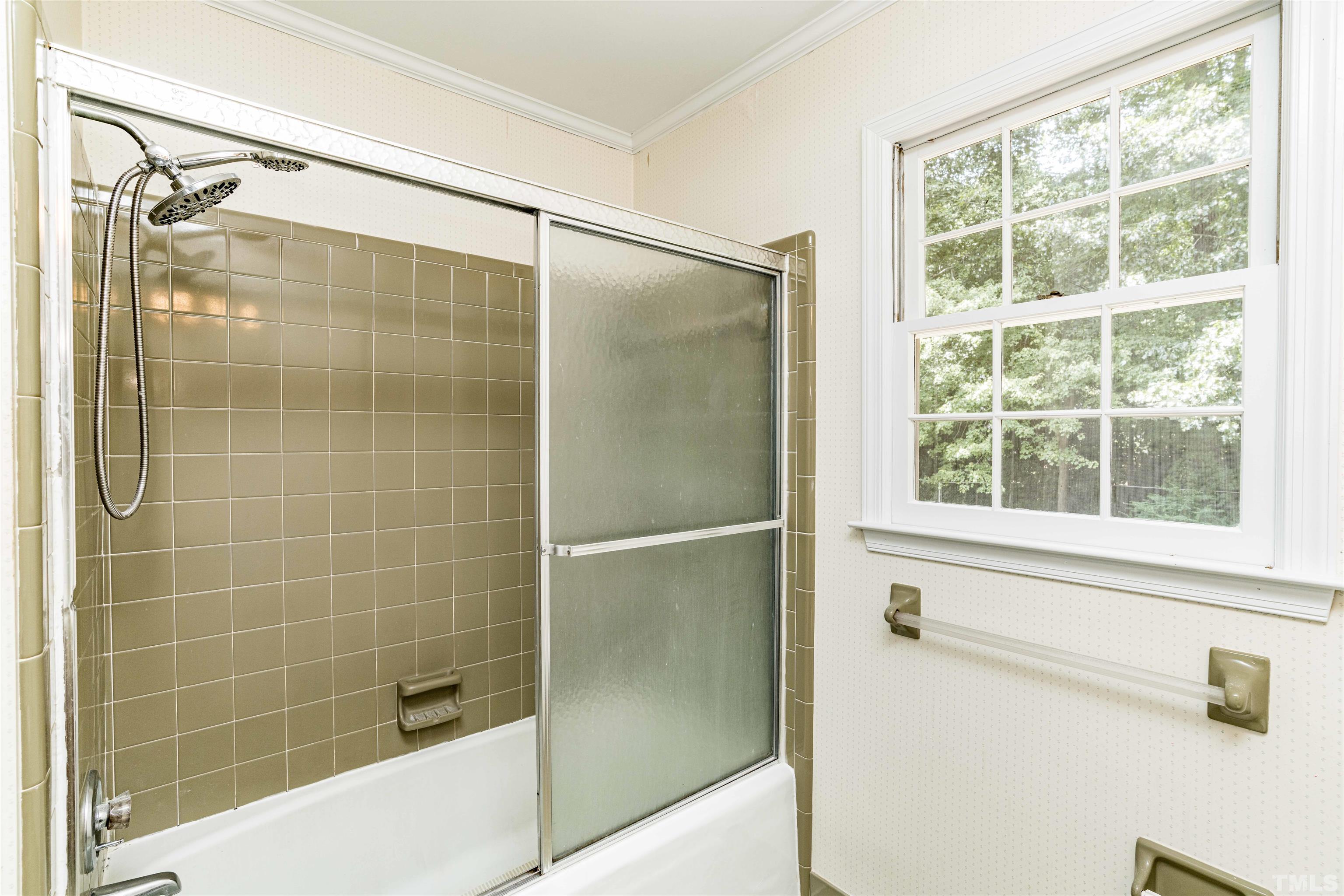 8645 Valley Brook Drive Raleigh, NC 27613 - Photo 28 of 32 a bathroom with a glass shower door